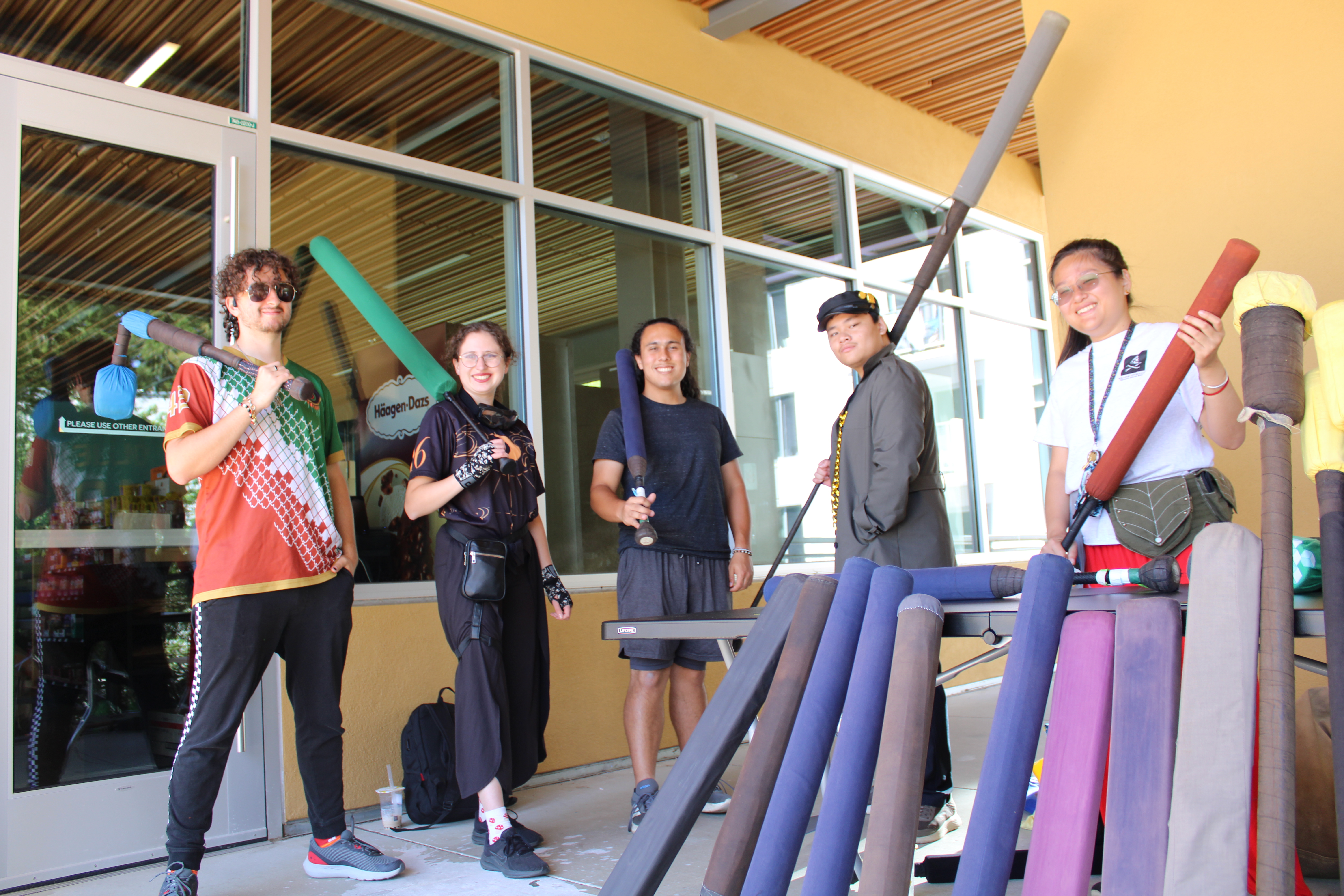group of five people showing off their foam fighting gear